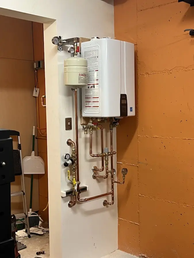 Plumbing technician inspecting water heater connections in Montevideo